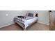 Neutral bedroom featuring carpet and a simple wood-framed bed at 2641 Vendange Pl, Henderson, NV 89044