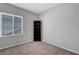 Minimalist bedroom with neutral walls, carpet, and a window for natural light at 2641 Vendange Pl, Henderson, NV 89044