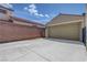 Spacious driveway leading to a two-car garage, surrounded by brick fencing at 2641 Vendange Pl, Henderson, NV 89044