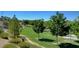 Lush green space in a community with walking paths, mature trees, and manicured landscaping at 2641 Vendange Pl, Henderson, NV 89044