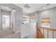 Bright hallway with neutral colors, leading to bedrooms, a closet, and a window at 2641 Vendange Pl, Henderson, NV 89044