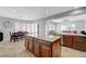 Open kitchen featuring an island with granite counters, stainless appliances, and an adjacent dining area at 2641 Vendange Pl, Henderson, NV 89044