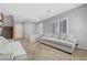 Bright living room with tile floors, a staircase, large windows and comfortable gray sofas at 2641 Vendange Pl, Henderson, NV 89044