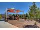 Community playground with slides, climbing structures, swings, covered picnic area, and lush greenery at 2641 Vendange Pl, Henderson, NV 89044