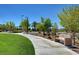 Scenic walking path featuring beautiful landscaping and a relaxing bench at 2641 Vendange Pl, Henderson, NV 89044