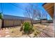 Expansive back yard with mature trees, desert landscaping, and partial patio cover at 3254 Greenbriar Dr, Las Vegas, NV 89121