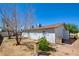 Backyard view featuring mature trees, desert landscaping, and convenient side access gate at 3254 Greenbriar Dr, Las Vegas, NV 89121