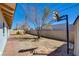 Spacious backyard featuring mature trees and partial view of the block wall at 3254 Greenbriar Dr, Las Vegas, NV 89121