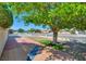 Relaxing backyard retreat featuring a tiled patio, shade tree, and views of the surrounding neighborhood at 3254 Greenbriar Dr, Las Vegas, NV 89121