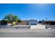 Inviting single-story home with a large driveway and a manicured front yard under a clear blue sky at 3254 Greenbriar Dr, Las Vegas, NV 89121