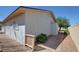 Exterior view of the house featuring a side yard with brick pavers and mature landscaping at 3254 Greenbriar Dr, Las Vegas, NV 89121