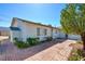 Well-maintained single-story home with brick accents, a security door, and mature landscaping at 3254 Greenbriar Dr, Las Vegas, NV 89121