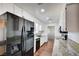 Modern kitchen with stainless steel appliances, granite counters, and wooden floors at 3254 Greenbriar Dr, Las Vegas, NV 89121