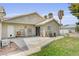 Comfortable backyard featuring a concrete patio, small lawn area, and partial fencing at 3581 Pahrump Valley Blvd, Pahrump, NV 89048