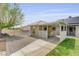 The backyard has a covered patio, small out-building, and block and chain-link fencing at 3581 Pahrump Valley Blvd, Pahrump, NV 89048