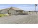 Exterior view of a residential property featuring ample parking, a low-maintenance yard and a covered parking area at 3581 Pahrump Valley Blvd, Pahrump, NV 89048