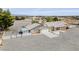 Expansive desert home with white fence, large gravel yard, and carport, offering ample space and parking at 3581 Pahrump Valley Blvd, Pahrump, NV 89048