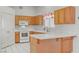 Bright kitchen with white countertops, wooden cabinets, and modern appliances, designed for functionality and style at 3581 Pahrump Valley Blvd, Pahrump, NV 89048
