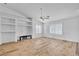 Inviting living room with built-in shelving, plantation shutters, and stylish wood-look flooring, perfect for relaxing at 3581 Pahrump Valley Blvd, Pahrump, NV 89048