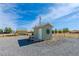 Small outbuilding with tiled roof, exterior decor, and rock landscaping at 3581 Pahrump Valley Blvd, Pahrump, NV 89048