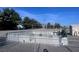 Fenced-in section of the yard with a manicured plot with pine trees in the background at 3581 Pahrump Valley Blvd, Pahrump, NV 89048