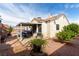Private backyard featuring a covered patio, desert landscaping, and mature trees at 436 Pumpkin Way, Henderson, NV 89015
