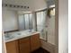Bathroom with double sinks, a large mirror, and a bathtub with shower featuring a glass sliding door at 436 Pumpkin Way, Henderson, NV 89015