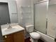 Bathroom featuring a single sink vanity, glass shelves, and tiled shower/tub combo at 436 Pumpkin Way, Henderson, NV 89015