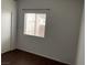 Simple bedroom with a window, dark laminate floors, and a closet at 436 Pumpkin Way, Henderson, NV 89015
