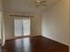 Bright bedroom with dark wood floors and a door to an outside patio at 436 Pumpkin Way, Henderson, NV 89015