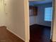 Open doorway leading to a bedroom with dark flooring, and a bright window at 436 Pumpkin Way, Henderson, NV 89015