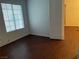 Bright and airy bedroom featuring a window, neutral walls, and hardwood floors at 436 Pumpkin Way, Henderson, NV 89015