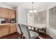 Bright breakfast nook features natural light, modern chandelier, and wood cabinets at 436 Pumpkin Way, Henderson, NV 89015