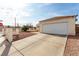 Single-story home with a spacious driveway and an attached two-car garage with a white door at 436 Pumpkin Way, Henderson, NV 89015