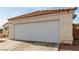 Close-up of a two-car garage with a white door and stucco facade at 436 Pumpkin Way, Henderson, NV 89015