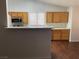 Eat-in kitchen featuring wood cabinets, stainless steel appliances and breakfast bar at 436 Pumpkin Way, Henderson, NV 89015