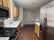 Modern kitchen featuring dark wood floors, stainless steel appliances, and bright lighting at 436 Pumpkin Way, Henderson, NV 89015