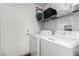 Convenient laundry room with washer, dryer, storage shelves, and door to outside at 436 Pumpkin Way, Henderson, NV 89015