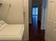 Laundry room with white appliances, wire shelving and view to the hallway at 436 Pumpkin Way, Henderson, NV 89015