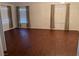 Spacious living room featuring hardwood floors, neutral walls, and natural light through the windows at 436 Pumpkin Way, Henderson, NV 89015