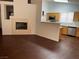 Living area features a fireplace, hardwood floors, and an adjacent kitchen at 436 Pumpkin Way, Henderson, NV 89015