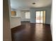 Open living space featuring dark wood floors, natural light, and a bar kitchen at 436 Pumpkin Way, Henderson, NV 89015