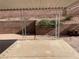 A covered patio features a concrete floor and a landscaped brick wall at 436 Pumpkin Way, Henderson, NV 89015