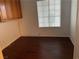 A cozy room featuring dark floors, neutral walls, and natural light from a window at 436 Pumpkin Way, Henderson, NV 89015