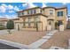 Welcoming two-story home features neutral tones, desert landscaping, concrete pavers, and a barrel tile roof at 489 Wendover Hills Ave, Las Vegas, NV 89123