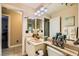 Bathroom showcasing a vanity, toilet, and doorway to the side room at 5412 Harmony Green Dr # 101, Las Vegas, NV 89149
