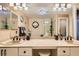 Bright bathroom with dual sinks, decorative lighting, and a large mirror at 5412 Harmony Green Dr # 101, Las Vegas, NV 89149