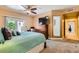 Bedroom featuring carpet, ceiling fan, and sliding doors to the outside at 5412 Harmony Green Dr # 101, Las Vegas, NV 89149
