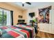Bedroom featuring a ceiling fan, hardwood flooring, and a large window at 5412 Harmony Green Dr # 101, Las Vegas, NV 89149