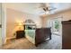 Cozy bedroom with a ceiling fan, carpet, and sliding glass door to the outside at 5412 Harmony Green Dr # 101, Las Vegas, NV 89149